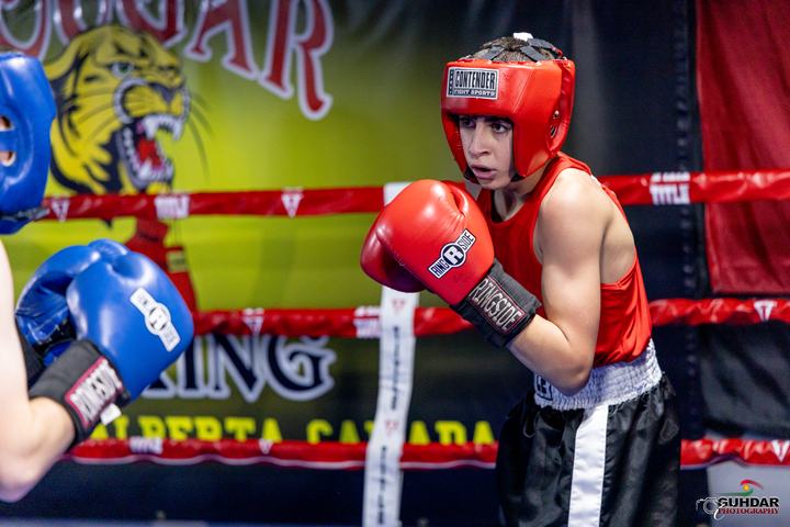 Young Cougar boxer in front of the club banner