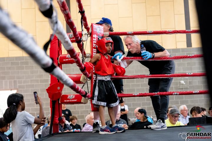 Coach Rick Cooper with a young boxer in the corner